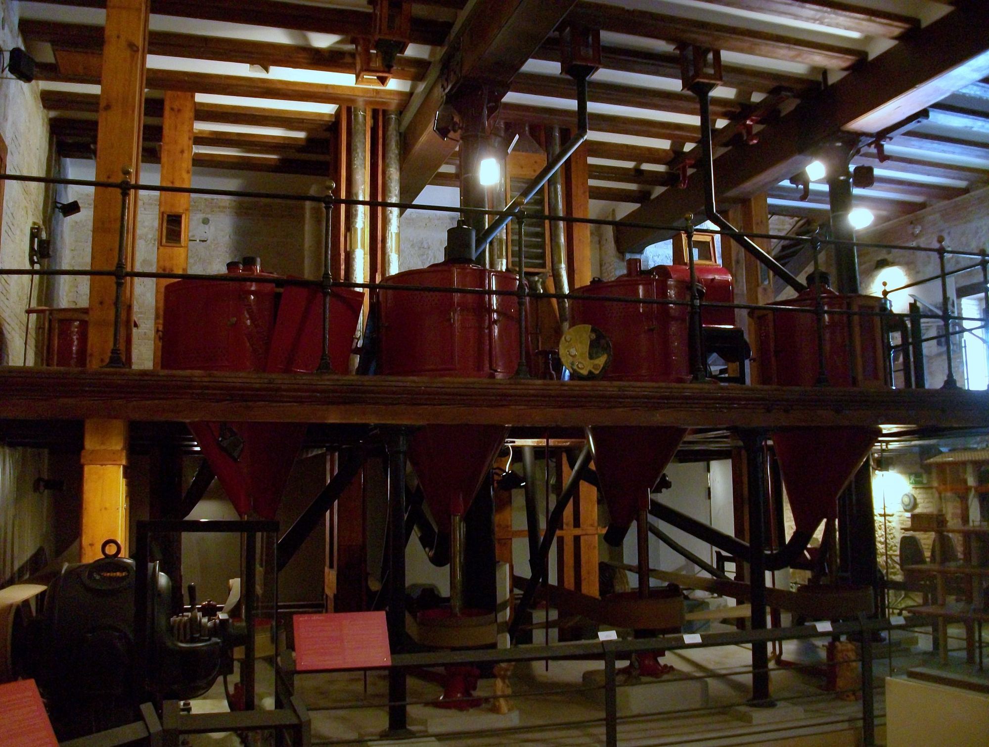 Rice whitening machines on the timber floor of a mill